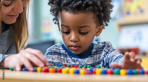 Kindergartener practicing counting with colorful beads guided by a teacher in a mathfocused activity