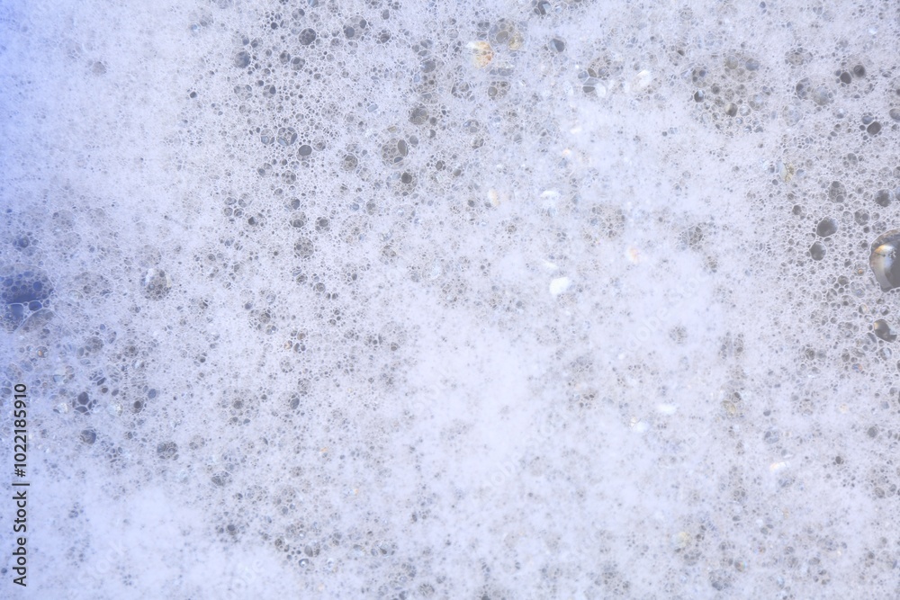 Fototapeta premium Detergent foam as background, top view. Hand washing laundry