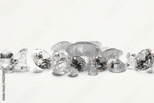 Many beautiful shiny diamonds on white background, closeup