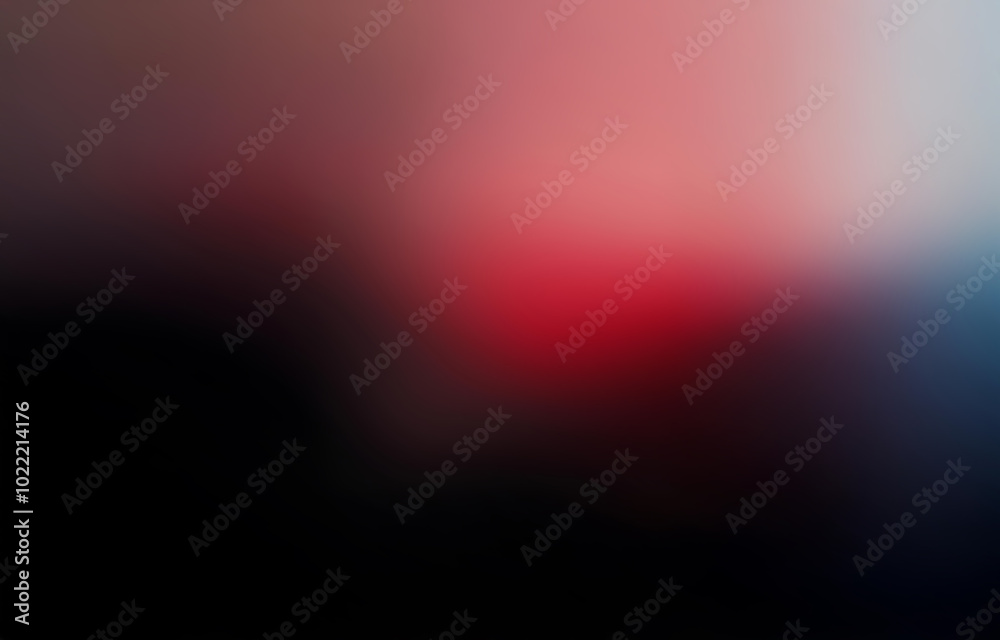 Obraz premium A blurry background with a gradient of red, pink, and blue, transitioning into black.
