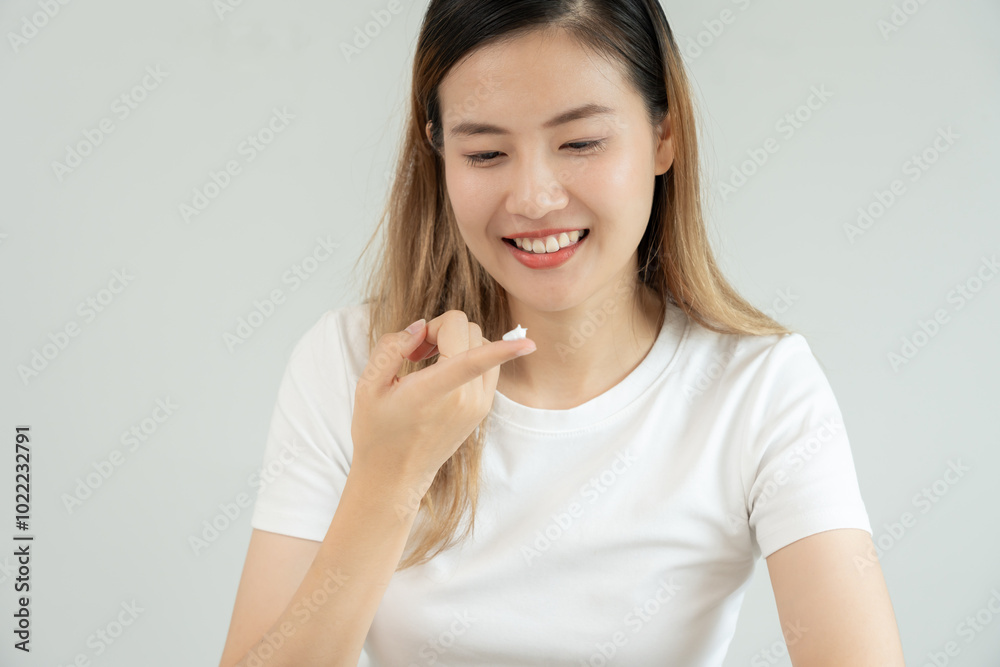 Beautiful Asian woman smile use cream for good skin. face of a healthy woman apply cream and makeup. Advertisement for skin cream, anti-wrinkle, baby face, whitening, moisturizer, tighten pores serum Beautiful Asian woman smile use cream for good skin. face of a healthy woman apply cream and makeup. Advertisement for skin cream, anti-wrinkle, baby face, whitening, moisturizer, tighten pores serum