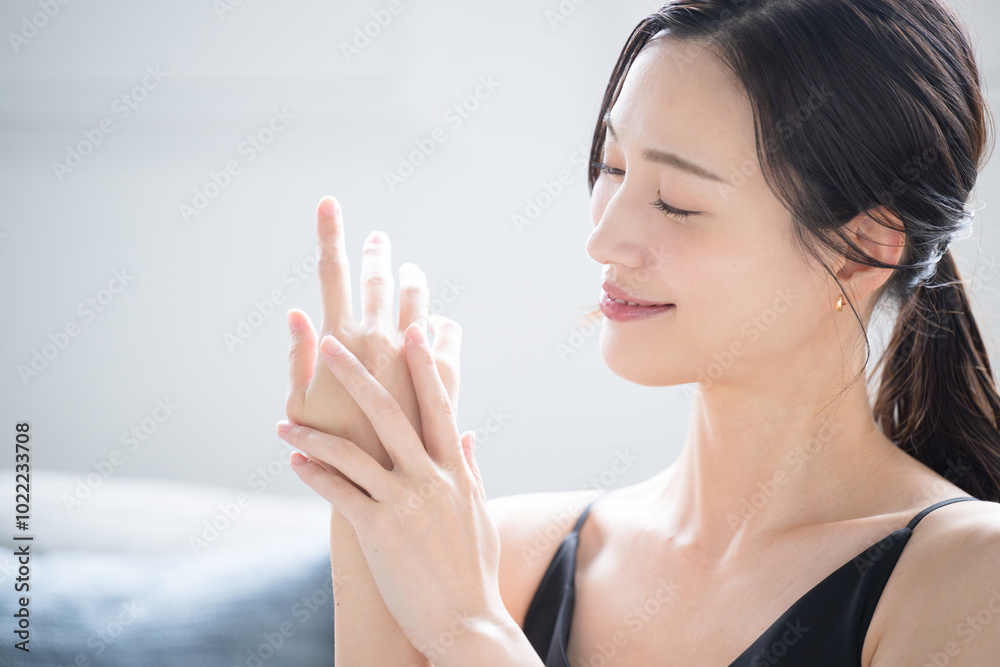 Beautiful woman applying cream that could be used for rough and dry hands in winter Close-up profile of image of hands Beautiful woman applying cream that could be used for rough and dry hands in winter Close-up profile of image of hands