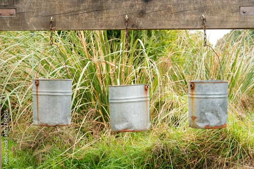 Three Iron Buckets Hanging from a Wooden Beam - Rustic and Vintage Display