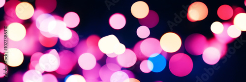 Abstract bokeh lights in pink, blue, and white.