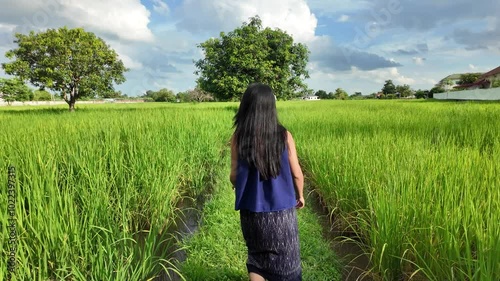 Beautiful thai farmer running  In the field at sunset.