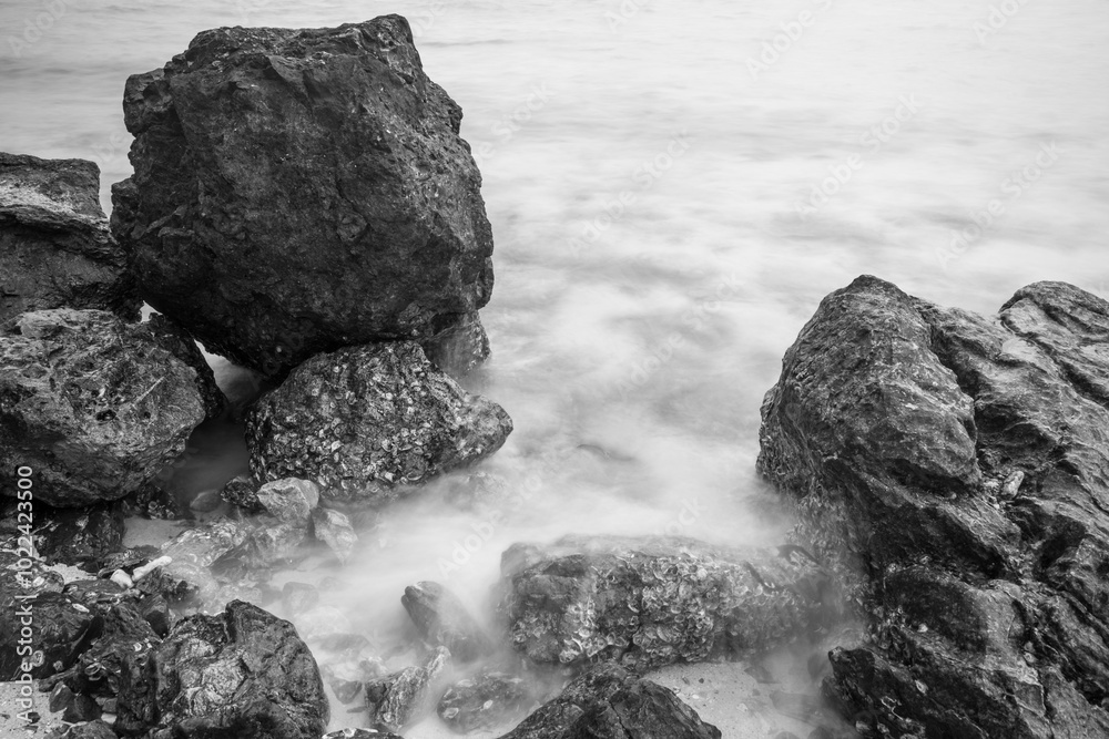 Long exposure photo of Nature’s Harmony: Rocks and Waves in Perfect Balance.Black and white photo Long exposure photo of Nature’s Harmony: Rocks and Waves in Perfect Balance.Black and white photo