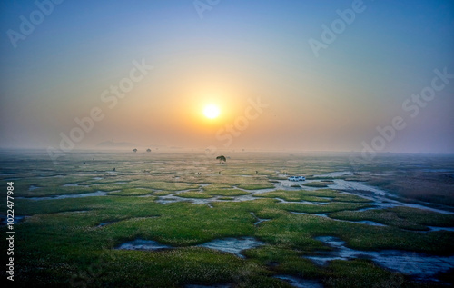 Aerial view of sunrise at Ueumdo Island near Hwaseong-si, Korea. Ueumdo Island has become a land due to the Sihwa Lake reclaimed land development. photo