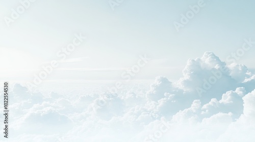 A serene sky filled with soft, fluffy clouds against a pale blue backdrop.