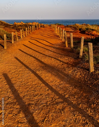 A red Pindan path leading to the Indian Ocean at Gantheaume Point, Broome Western Australia. photo