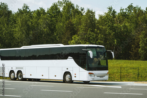 Roadside bus stop with white coach photo