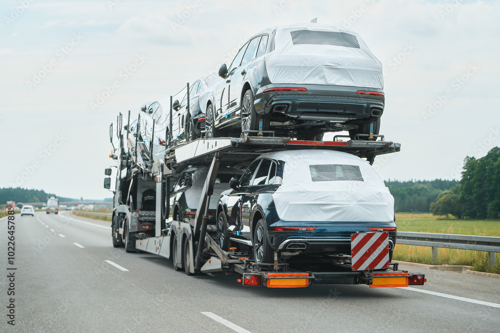 New cars on trailer truck moving on road New cars on trailer truck moving on road
