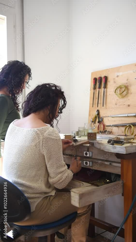 Two twin jewelers work collaboratively in their well-equipped workshop, meticulously designing and creating beautiful jewelry pieces. Their shared passion and skills shine through in every detail. Two twin jewelers work collaboratively in their well-equipped workshop, meticulously designing and creating beautiful jewelry pieces. Their shared passion and skills shine through in every detail.
