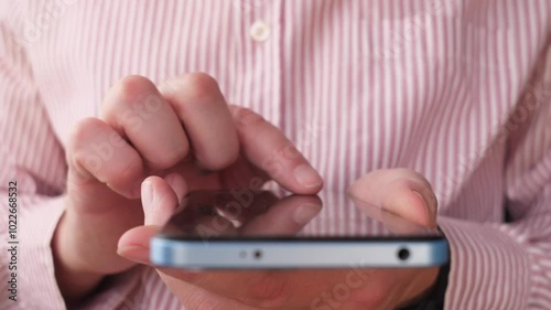 hands writing a message on a smartphone close
