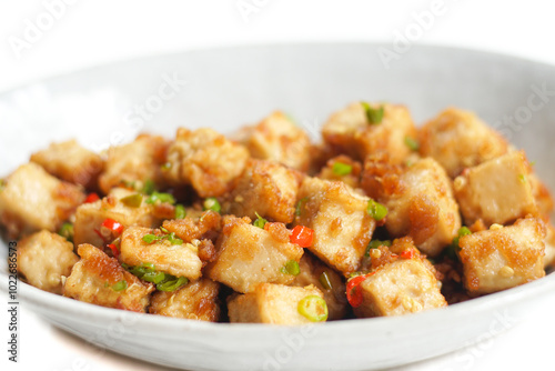 Stirred Tofu: Vegetarian Asian Style.This vibrant dish features crispy stir-fried tofu, perfectly marinated for flavor and texture. The tofu is coated in soy sauce and sesame oil, a rich umami taste.