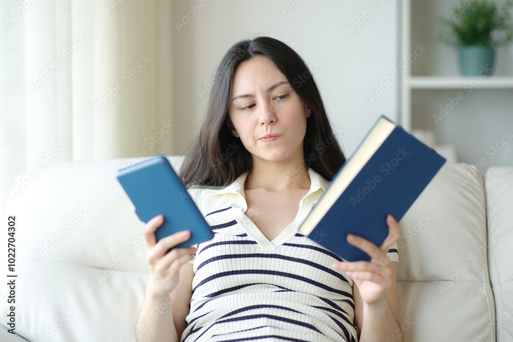 Undecided asian woman doubting between paper book or ebook Undecided asian woman doubting between paper book or ebook