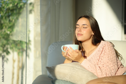 Woman relaxing at home drinking tea