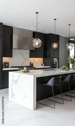 Modern kitchen with marble island and black chairs.