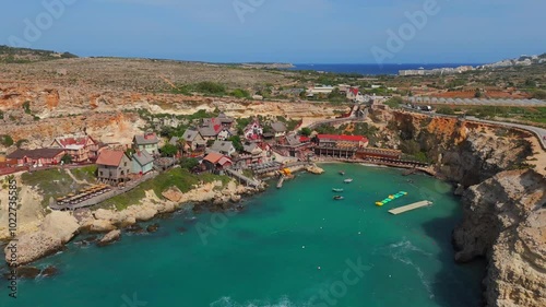 Aerial perspective of Popeye Village, revealing its iconic colorful houses and breathtaking Maltese coastline.