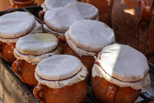 early morning close up of tagine earthenware clay pots covered in cloth on a fire in Marrakesh, Morocco