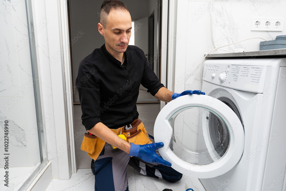 Obraz premium studio photo of washing machine repairman