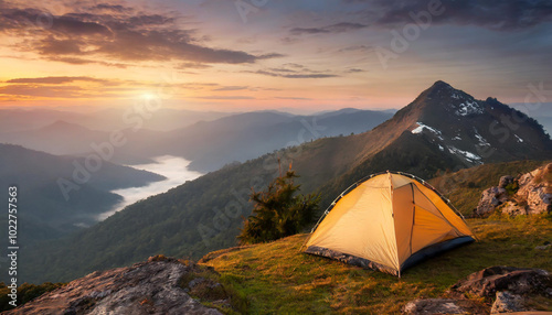 A peaceful camping site with a yellow tent nestled among rocky terrain at sunset in the mountains