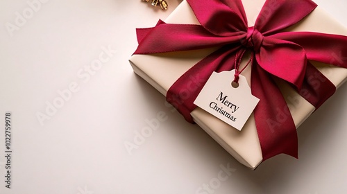 A beautifully wrapped gift with a red bow and a tag reading "Merry Christmas," perfect for holiday celebrations.