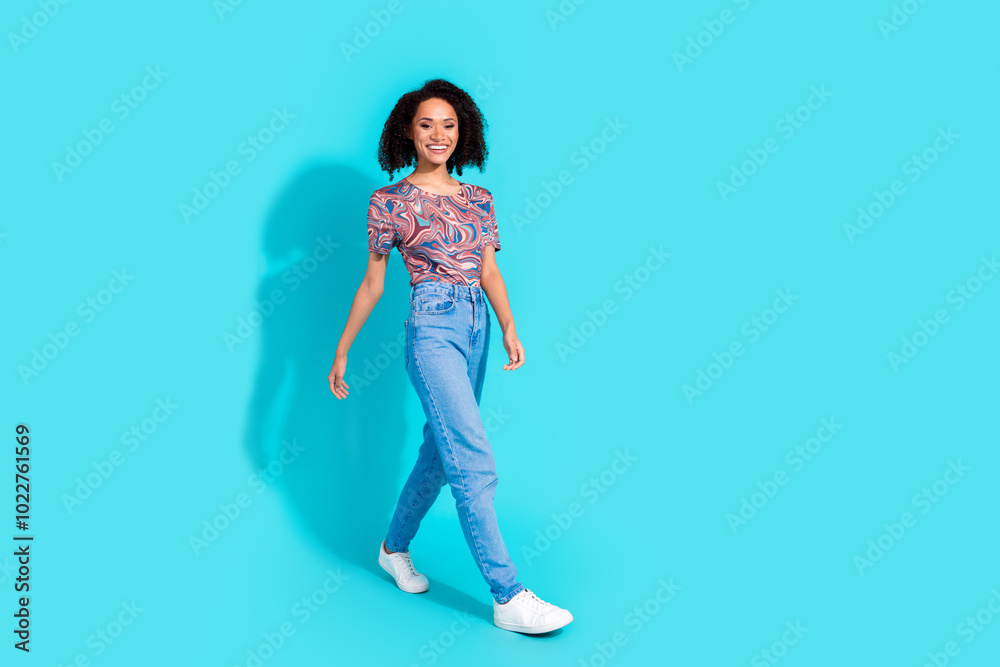 Full body photo of pretty young girl walking wear trendy colorful clothes isolated on aquamarine color background Full body photo of pretty young girl walking wear trendy colorful clothes isolated on aquamarine color background