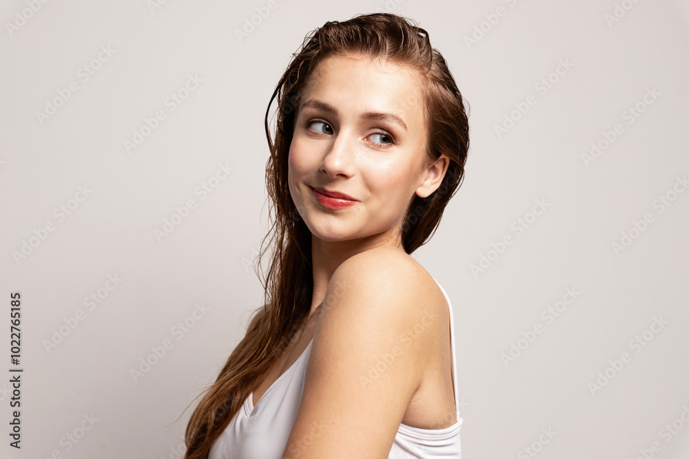 Beautiful woman enjoying soft smooth skin . Smiling model looking aside. Studio portrait Beautiful woman enjoying soft smooth skin . Smiling model looking aside. Studio portrait