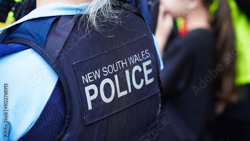 crime in sydney. Close up of a NSW Police officers uniform sleeve patch and his communication device. australia police