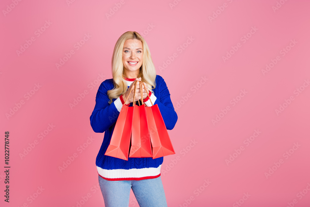 Photo of pretty lady hold store shop bags empty space wear blue sweater isolated on pink color background Photo of pretty lady hold store shop bags empty space wear blue sweater isolated on pink color background