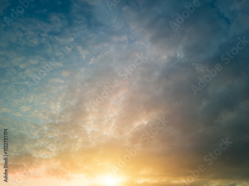 The rays of the sun breaking through the dramatic clouds in the evening or in the morning in the sunset or sunrise sky.