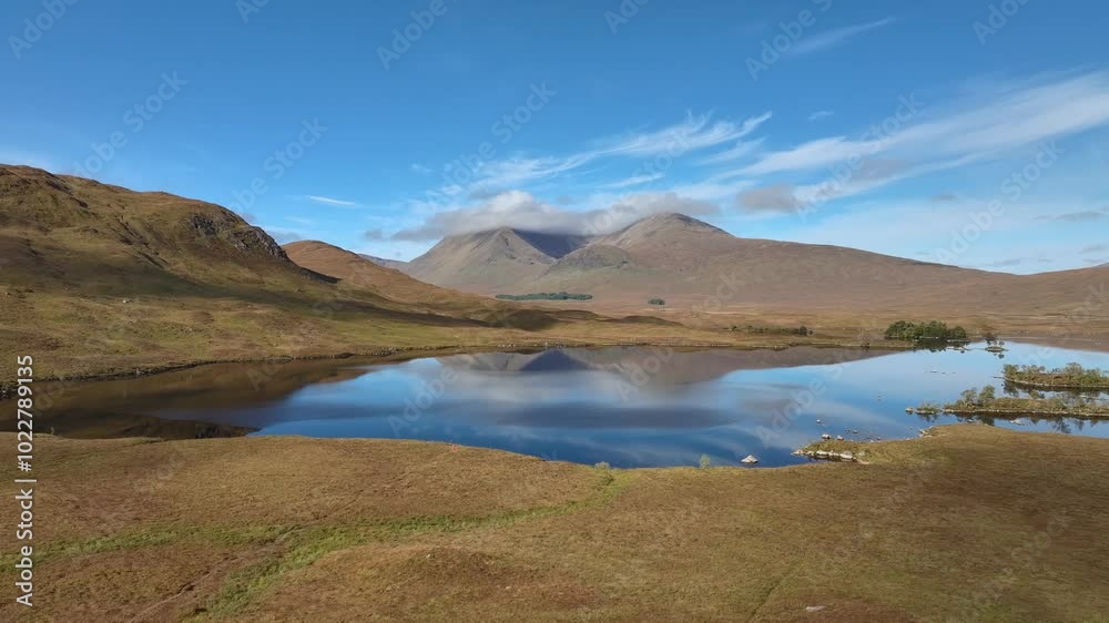 Mirror calm lake surface reflecting mountains and clouds at Lochan na h-Achlaise, Rannoch Moor, Glencoe. Mirror calm lake surface reflecting mountains and clouds at Lochan na h-Achlaise, Rannoch Moor, Glencoe.