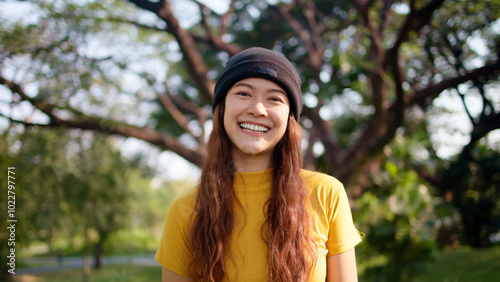 Go green culture Gen z asia people young adult woman curly hair enjoy cheerful relax toothy smile happy face looking at camera nature tree public park save the earth eco friendly city life future hope photo