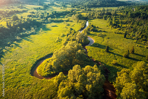 The charming green valley of the winding Stryi river on a sunny day. Carpathian mountains, Ukraine, Europe.