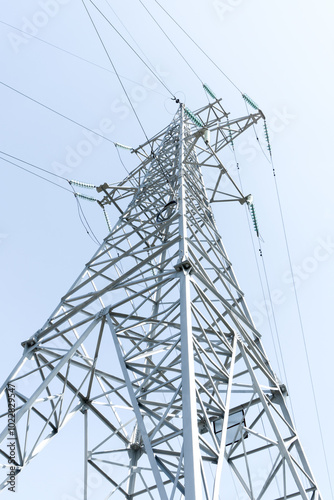 High-voltage power line support against the blue sky