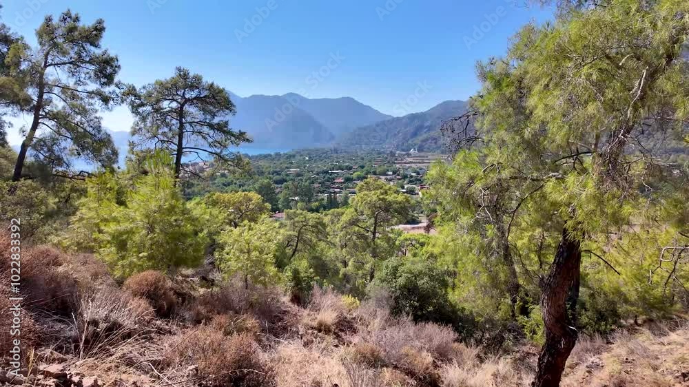 Turkish Mediterranean coastline as seen from the Lycian Way in Antalya, Turkey with a blue sea, lush green forests, and rugged rocky shores, attracting tourists every summer. Turkish Mediterranean coastline as seen from the Lycian Way in Antalya, Turkey with a blue sea, lush green forests, and rugged rocky shores, attracting tourists every summer.