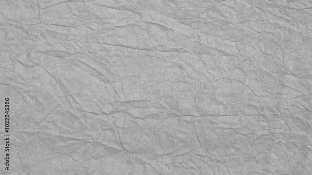 Gray crumpled paper background moves. Flat lay. Stop motion.