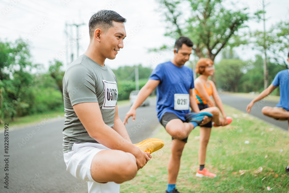 Fototapeta premium marathon athlete stretching or warming up before running