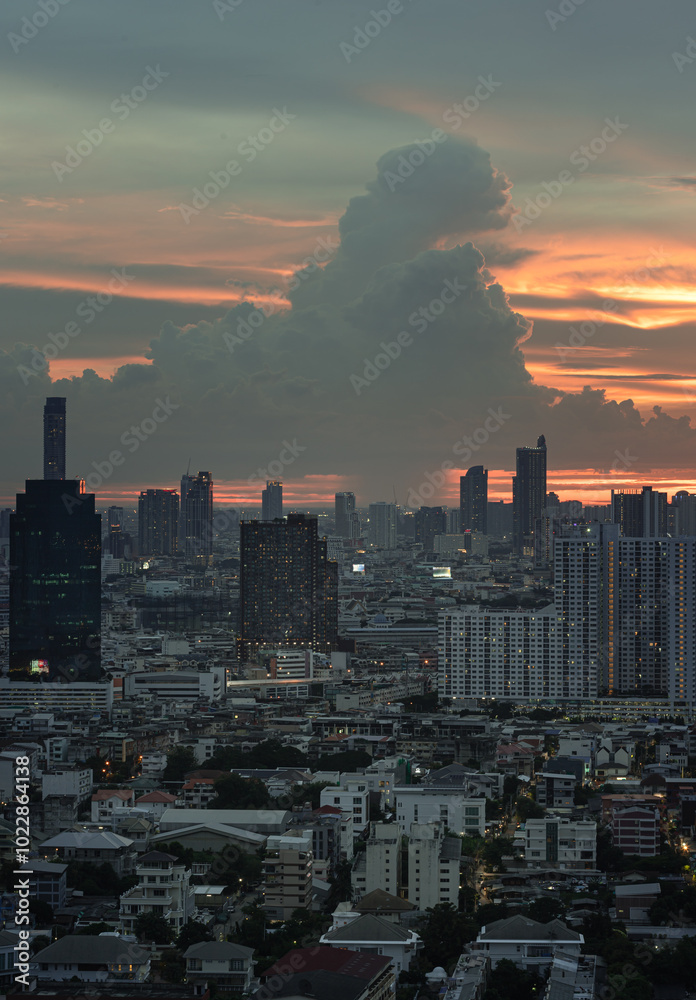 View of Beautiful Clouds in the Sky over Large Metropolitan City. Bangkok city skyscrapers after sunset with Dramatic sky background before Sunset, Space for text, Selective focus.