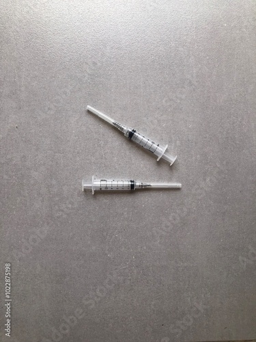 syringe and needle on plain background