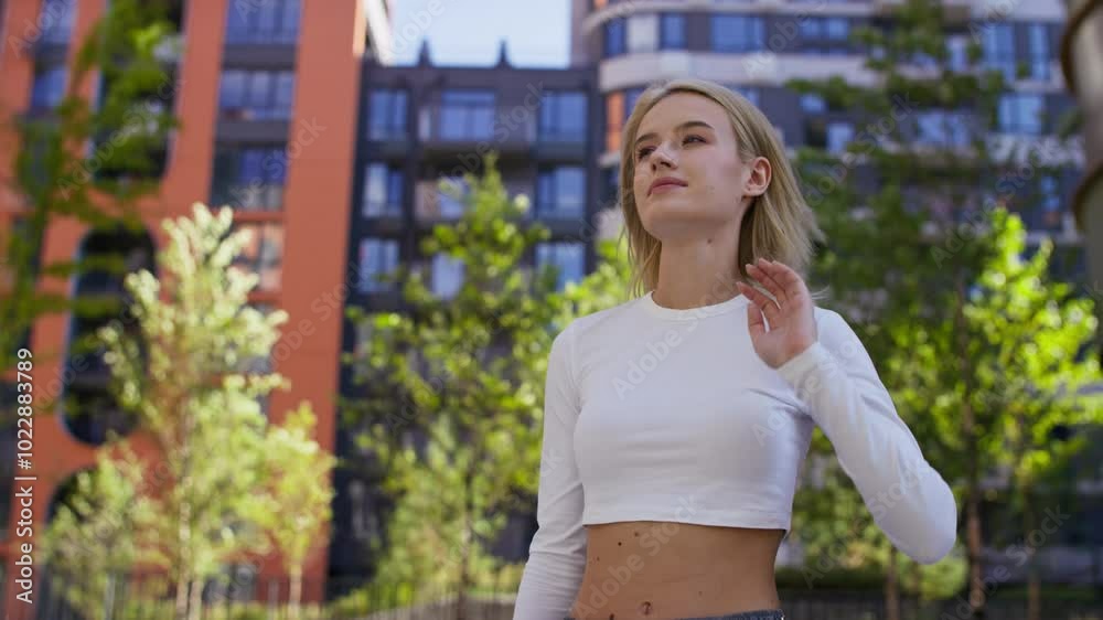 Confident young woman standing outdoors in urban setting Confident young woman standing outdoors in urban setting