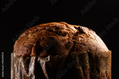Christmas panettone on a dark background with dramatic lighting close up macro detail