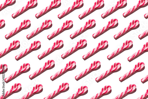 Obraz na płótnie Top view of assorted red and white candy spoon on white background making a pattern w salonie