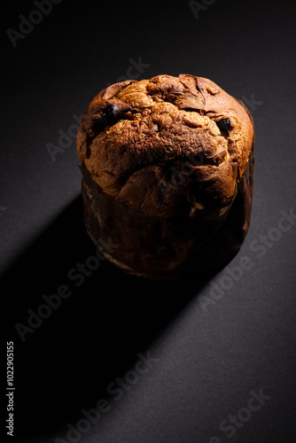 Obraz na płótnie Christmas panettone on a dark background with dramatic lighting copy space in a vertical composition w salonie