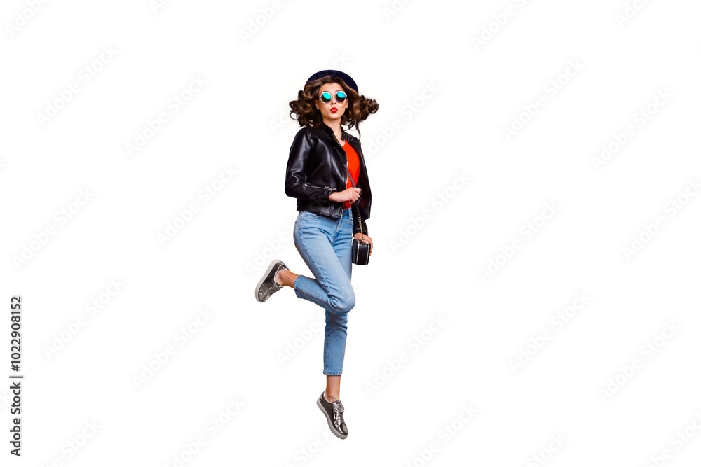 Full length photo of cute charming girl jump send air kiss on her journey attract men wear black leather jacket denim jeans isolated over yellow color background Full length photo of cute charming girl jump send air kiss on her journey attract men wear black leather jacket denim jeans isolated over yellow color background