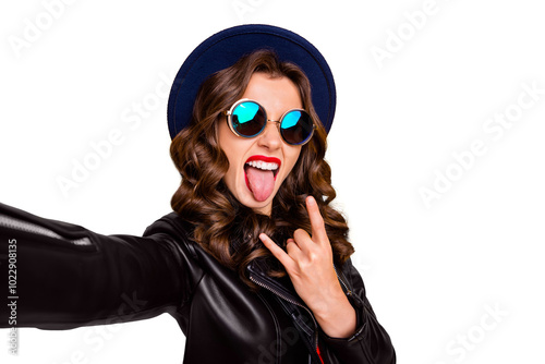 Close up photo of cheerful girl blogger influencer on rock-and-roll heavy party make selfie show horns symbol wear black leather jacket isolated over yellow color background photo