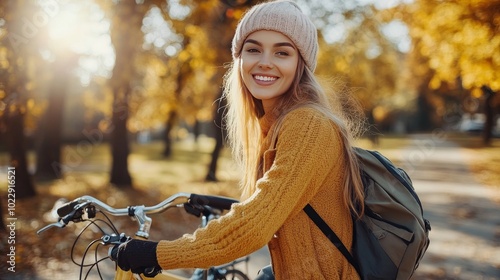 Posing next to her bike in a lovely autumn park, a happy, active woman. Concept of a healthy lifestyle and recreational activities