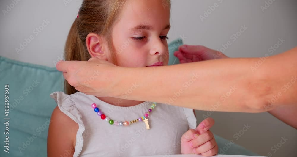 Mother Helping Daughter Wear Handmade Bead Necklace Mother Helping Daughter Wear Handmade Bead Necklace