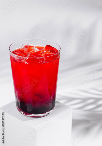 Wallpaper Mural Red cocktail with ice and blackberries on white background with palm leaf shadow Torontodigital.ca