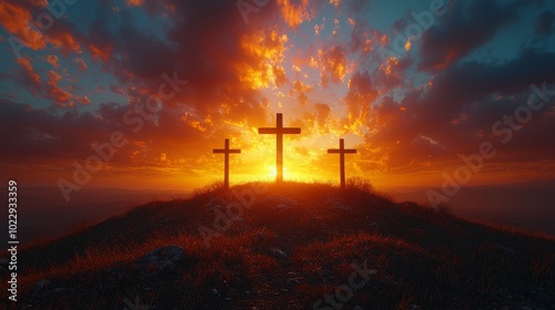 Three wooden crosses are silhouetted against a dramatic sunset with a fiery sky, evoking the crucifixion of jesus christ and the hope of resurrection